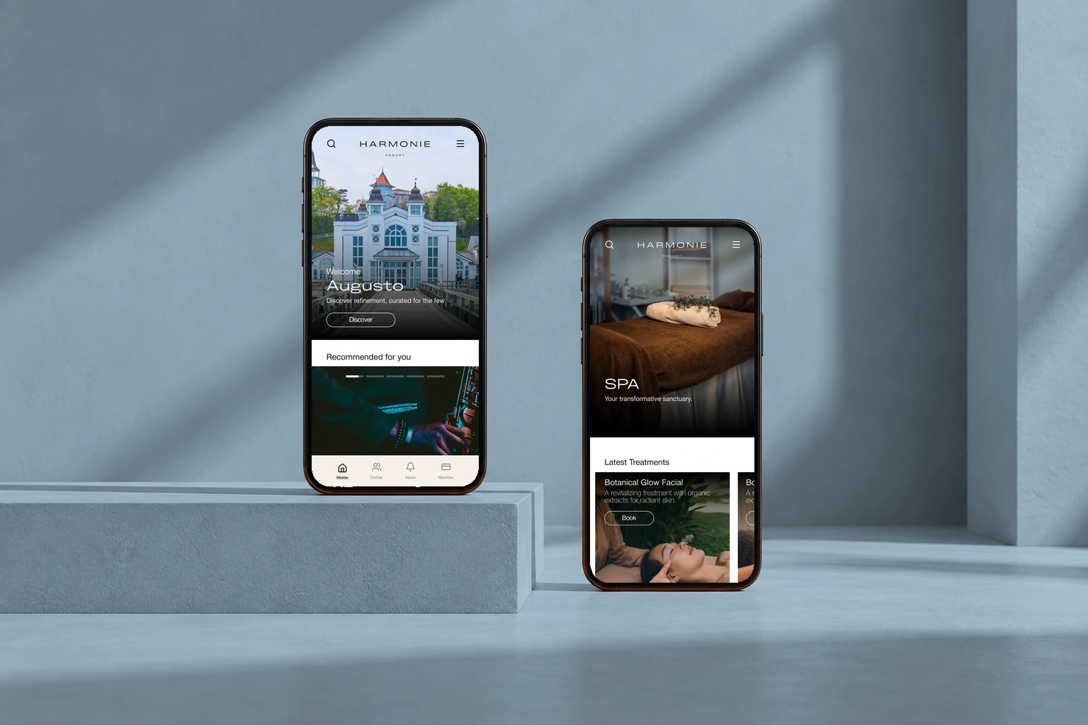 Original Harmony hotel membership designs in two phones against a blue-gray background