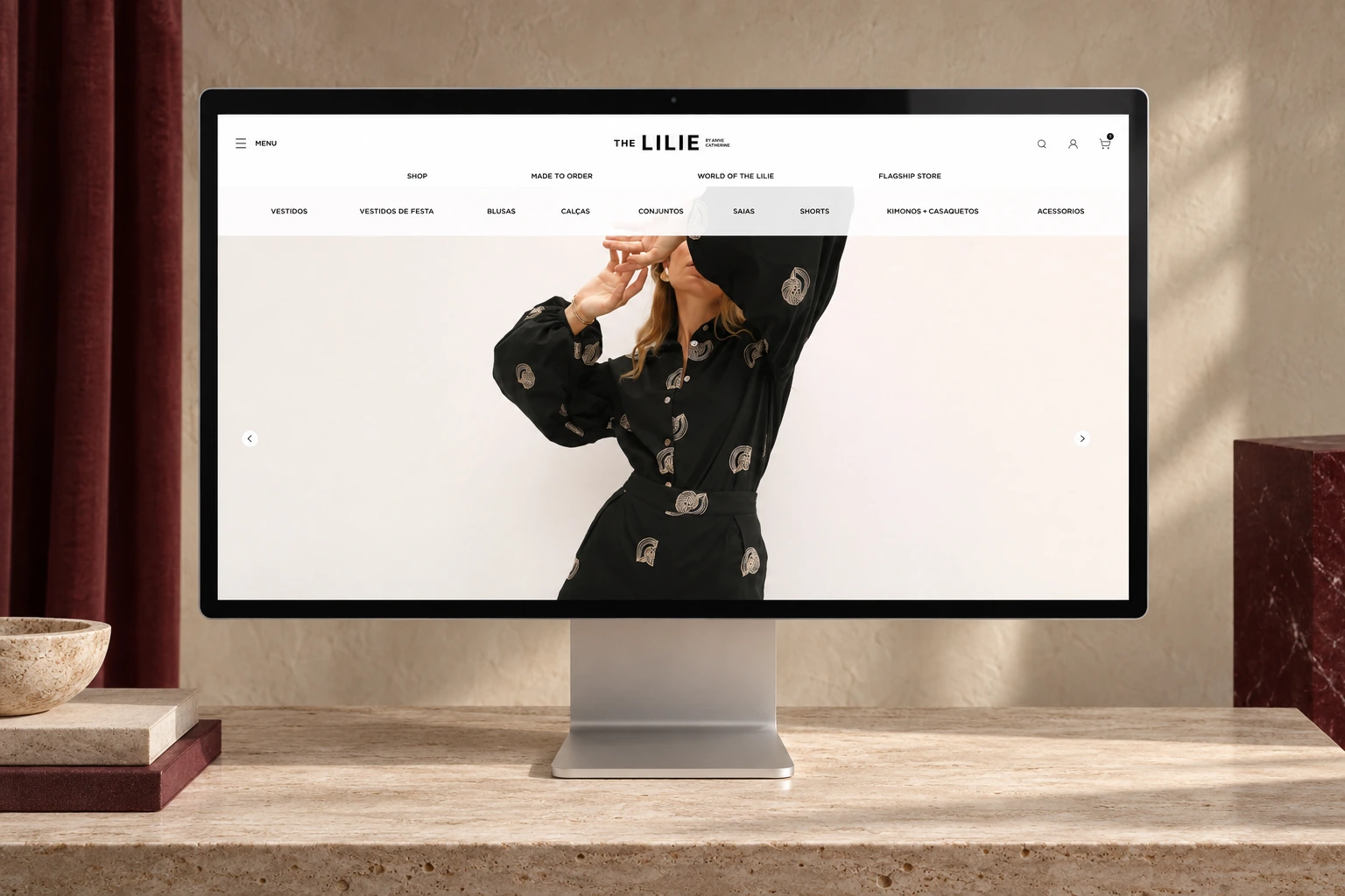 The Lilie fashion e-commerce homepage displayed on a Studio Display in a warm editorial fashion set
